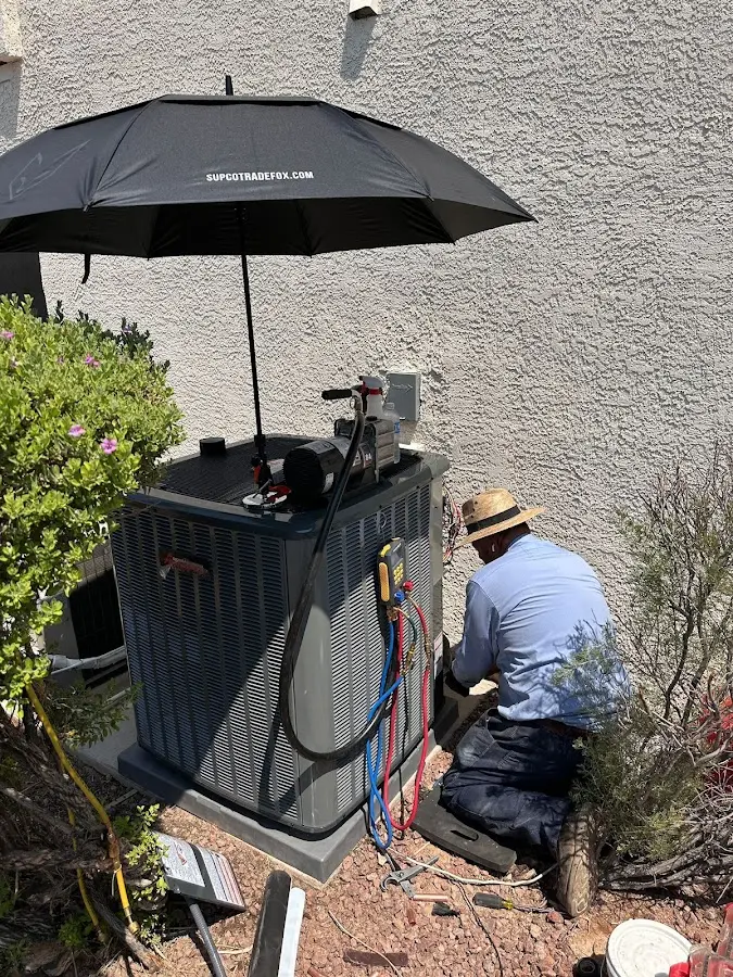 HVAC technician performing outdoor AC maintenance in Big Bear Lake
